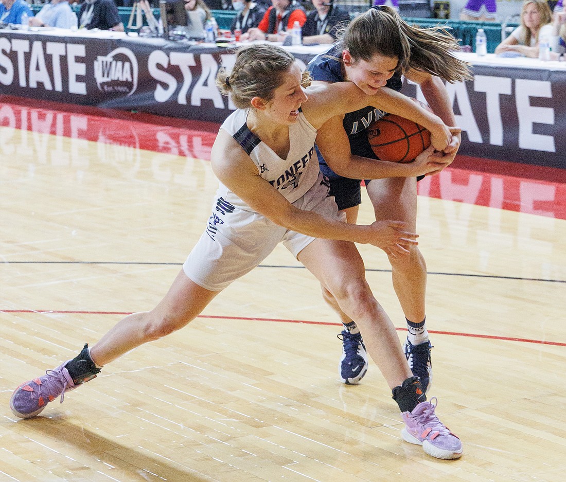 Nooksack Valley’s Devin Coppinger and Lynden Christian’s Grace Hintz battle for the ball in the fourth quarter of the girls 1A state championship title at the Yakima Valley SunDome on March 5.