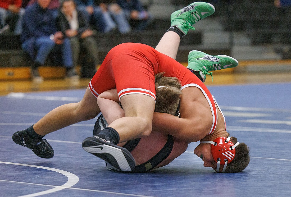Bellingham's Pavel Shintar wraps up Meridian's Julian Pullar for the pin during a dual meet at Squalicum on Dec. 7.