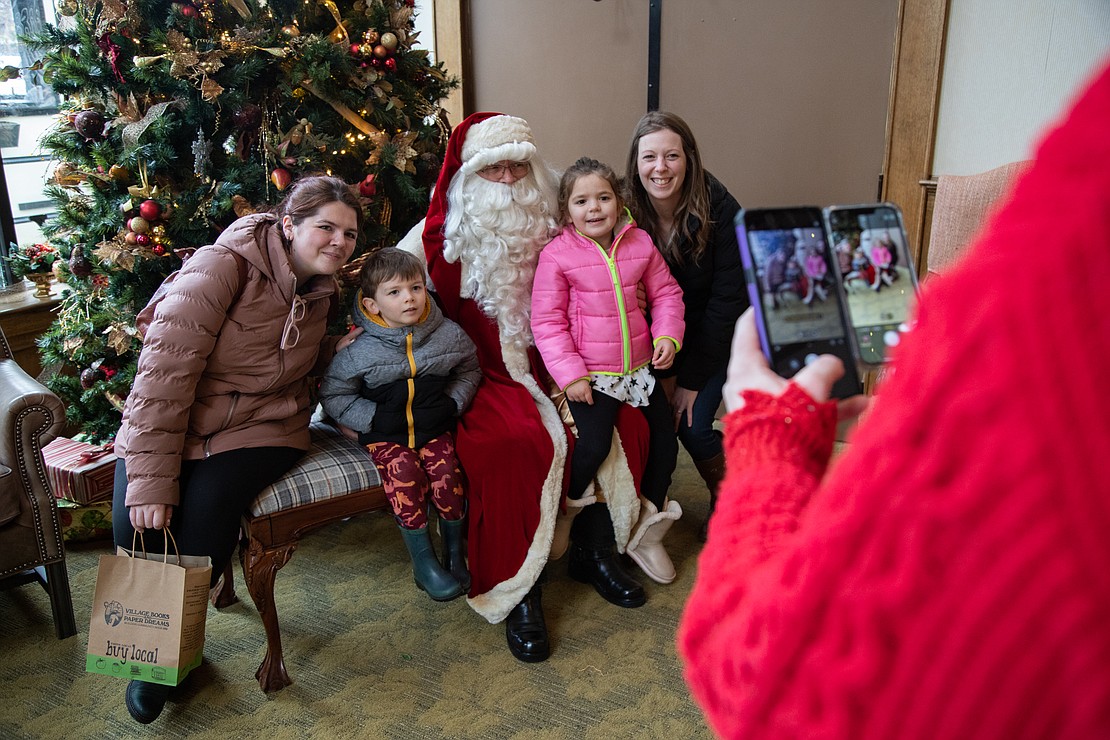 From left, Kassandra Raether, Carson Brook, Jennifer Ballew and Kiley Ballew take a photo with Santa Claus at the Fairhaven Village Inn on Dec. 10. The hotel hosts Santa for photos on Saturdays in December as part of the Fairhaven Winterfest put on by the Fairhaven Association.
