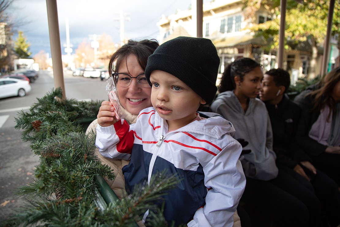 Jackie Benesch, left, and her grandson Oakley Barrow, 2, ride the carriage through Fairhaven.