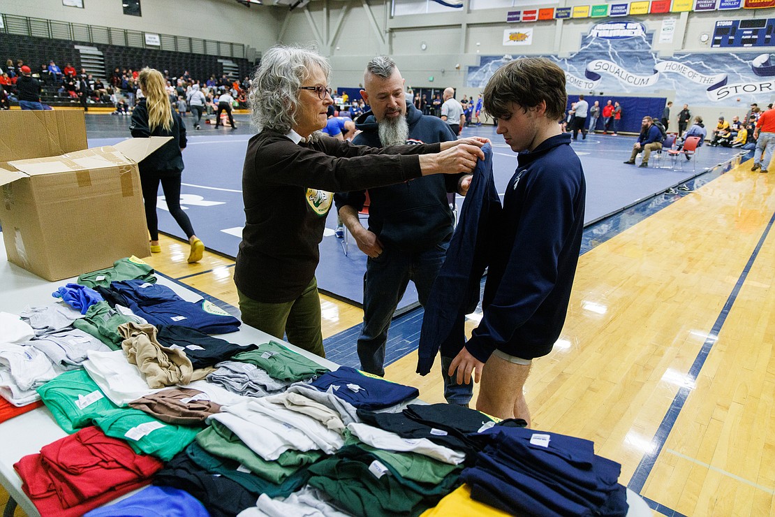 Laurie Morin, Graham Morin's mother, sizes Kane Odenius for a T-shirt. The shirts are sold to raise money for a scholarship in Graham's honor.