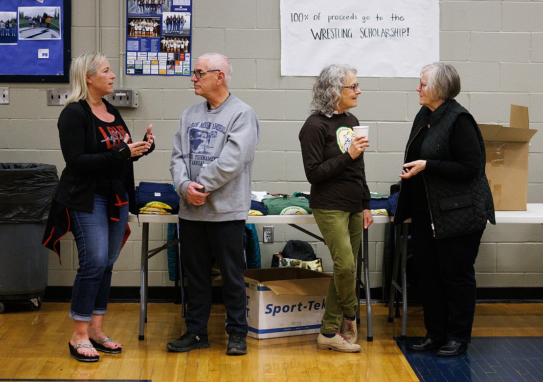 Phred Morin and his wife, Laurie, chat with friends Justy Mayernik, left, and Jackie Brooks, right.