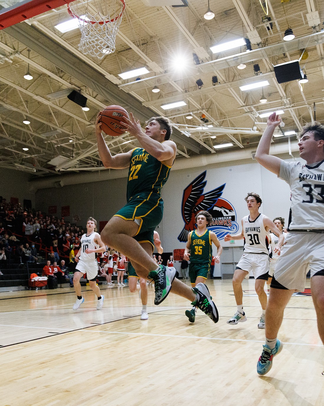 Sehome's Tommy Funk makes a sprinting leap to the basket in the fourth quarter against Bellingham on Dec. 19.