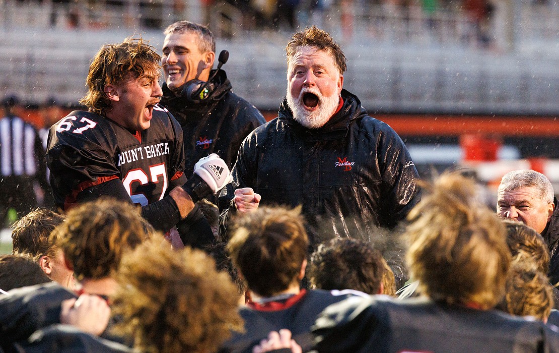 Mount Baker football coach Ron Lepper celebrates with his team after beating Nooksack Valley in a Kansas tiebreaker game to advance to the 1A state tournament on Nov. 3.