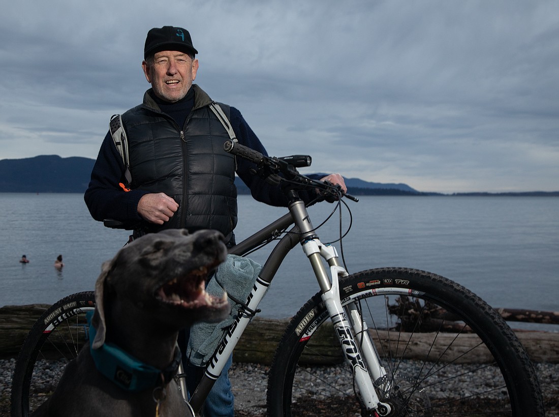 Tim Davenport and his weimaraner Grady stand on the beach at Marine Park on Jan. 6. The pair biked down to the park for Davenport to take a dip in the water and for Grady to romp around in the grass.