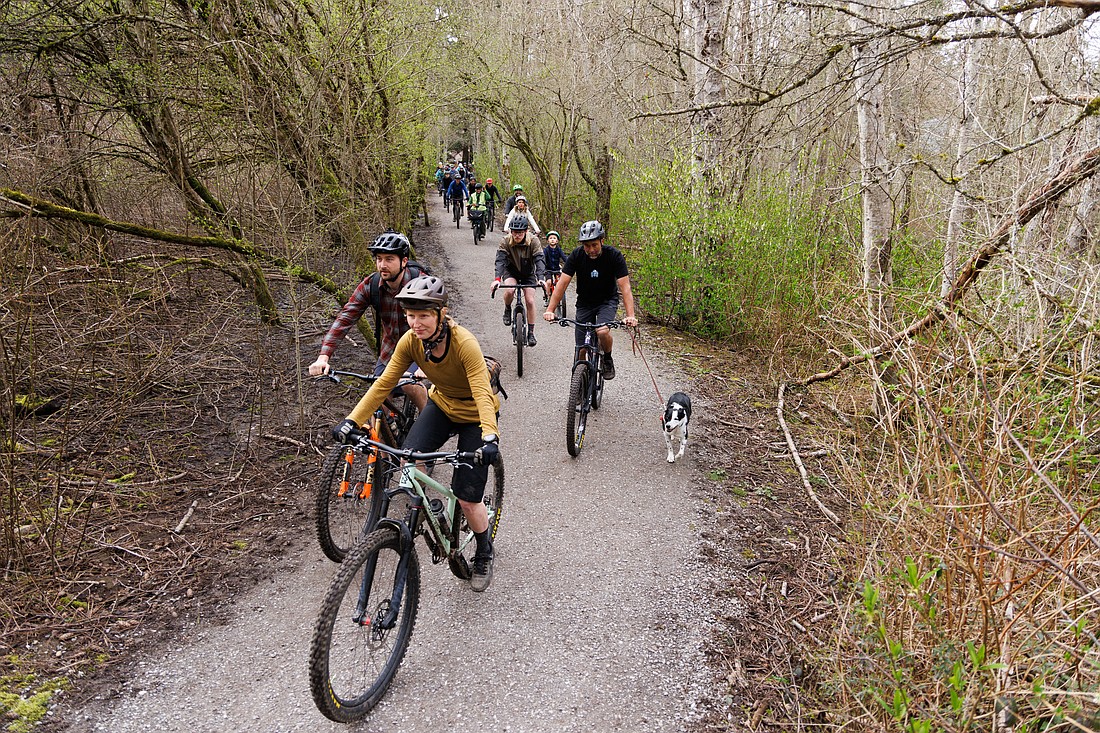 Bicyclists ride through Hundred Acre Wood Park in March. Recreational use in the park has been a sticking point for some park board members who prefer to prioritize preservation.