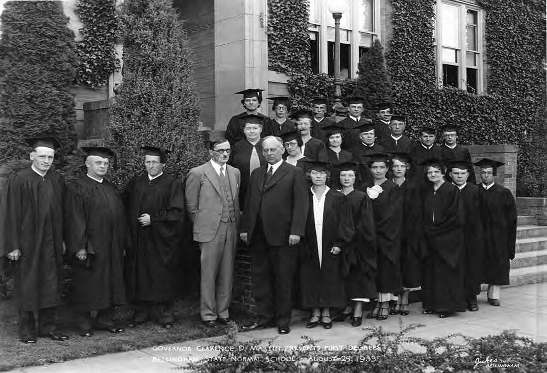 Western President Charles Fisher, center right, together with Gov. Clarence Martin, center left, with the graduating class of 1933 in front of the campus building now known as Old Main. In an action that would taint Fisher's reputation for life, Martin, a conservative Democrat, would later pressure the college Board of Trustees to force Fisher from office.