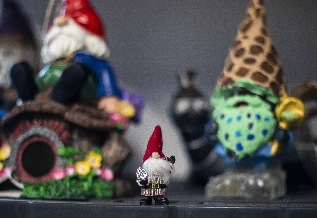A small gnome sits on a shelf on Dec. 22, 2022, in Sultan, Snohomish County. Each month, subscribers to Gnome of the Month Club receive a surprise gnome-inspired lawn ornament, along with a knick-knack like a mug, T-shirt, fridge magnet or bumper sticker.