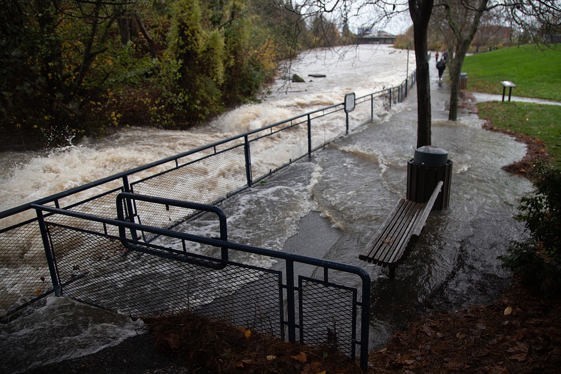 Whatcom Creek floods over its banks at Maritime Heritage Park on Nov. 15, 2021. New legislation would add a goal to the state's Growth Management Act and address adverse impacts of extreme weather events.