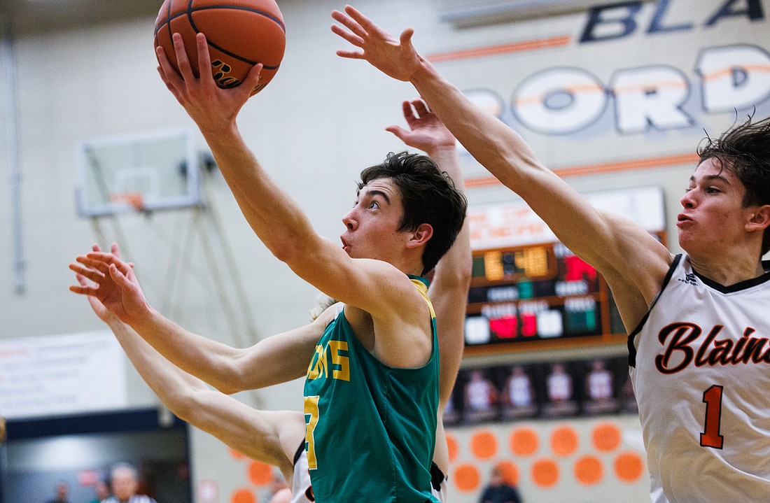 Lynden’s Coston "Bubba" Parcher gets past the Borderite defense for a layup as the Lions beat Blaine 75-47 on Jan. 12. Parcher led the Lions with 31 points.