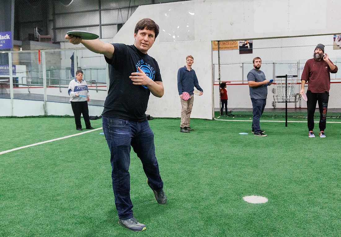 Jason Einfeld describes the proper body and arm positioning for throwing during a disc golf class at the Sportsplex on Jan. 13. The class, held by the Whatcom Disc Golf Club, is the first of three disc golf clinics this month.