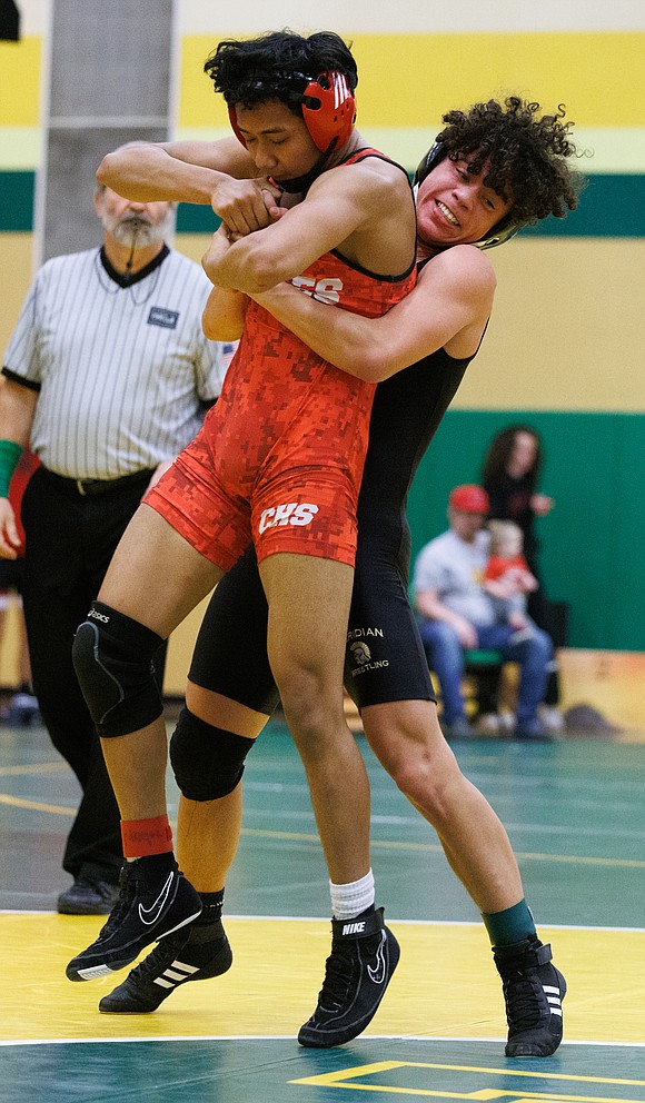 Meridian's Jackson Miller picks up his opponent during their match on Jan. 21. Miller won 12-6.