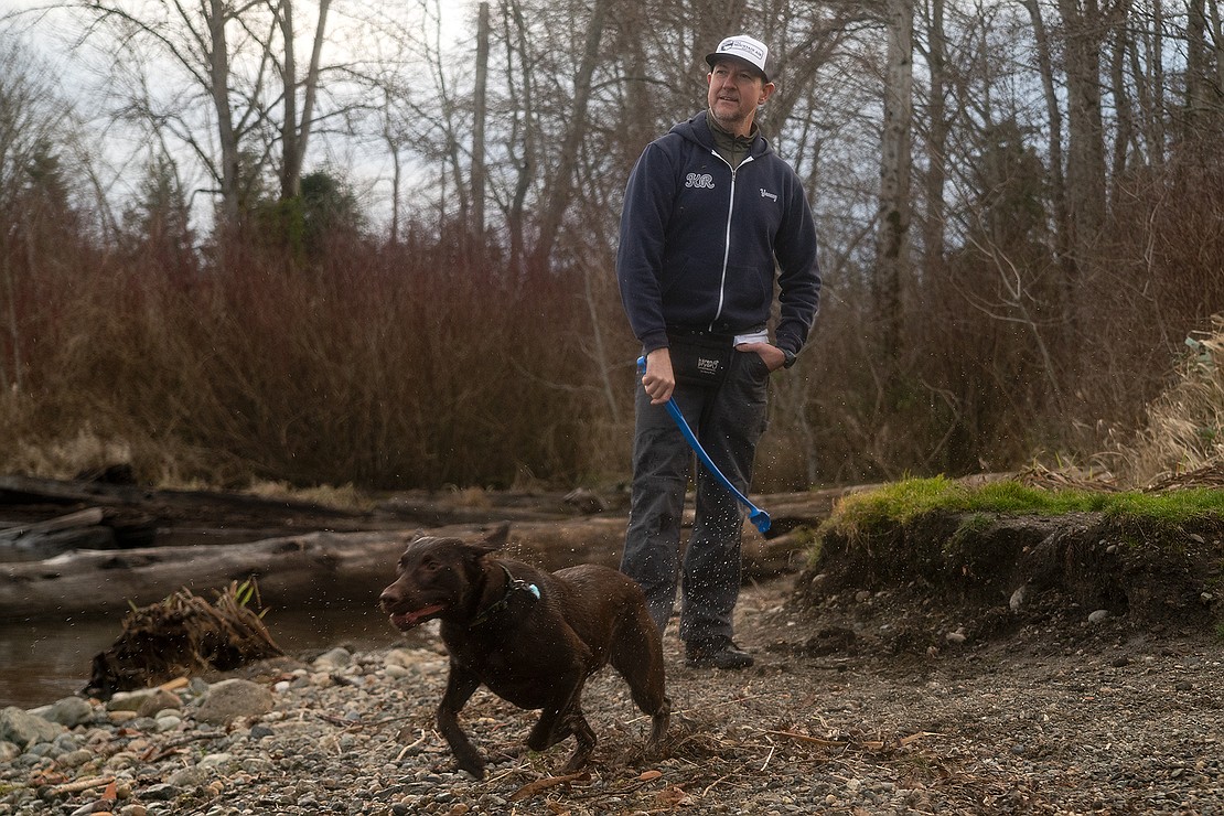 Yancey Kangas plays fetch with his year-old female chocolate Lab, Olive, along the shore of Lake Whatcom near Bloedel Donovan Park Jan. 11.