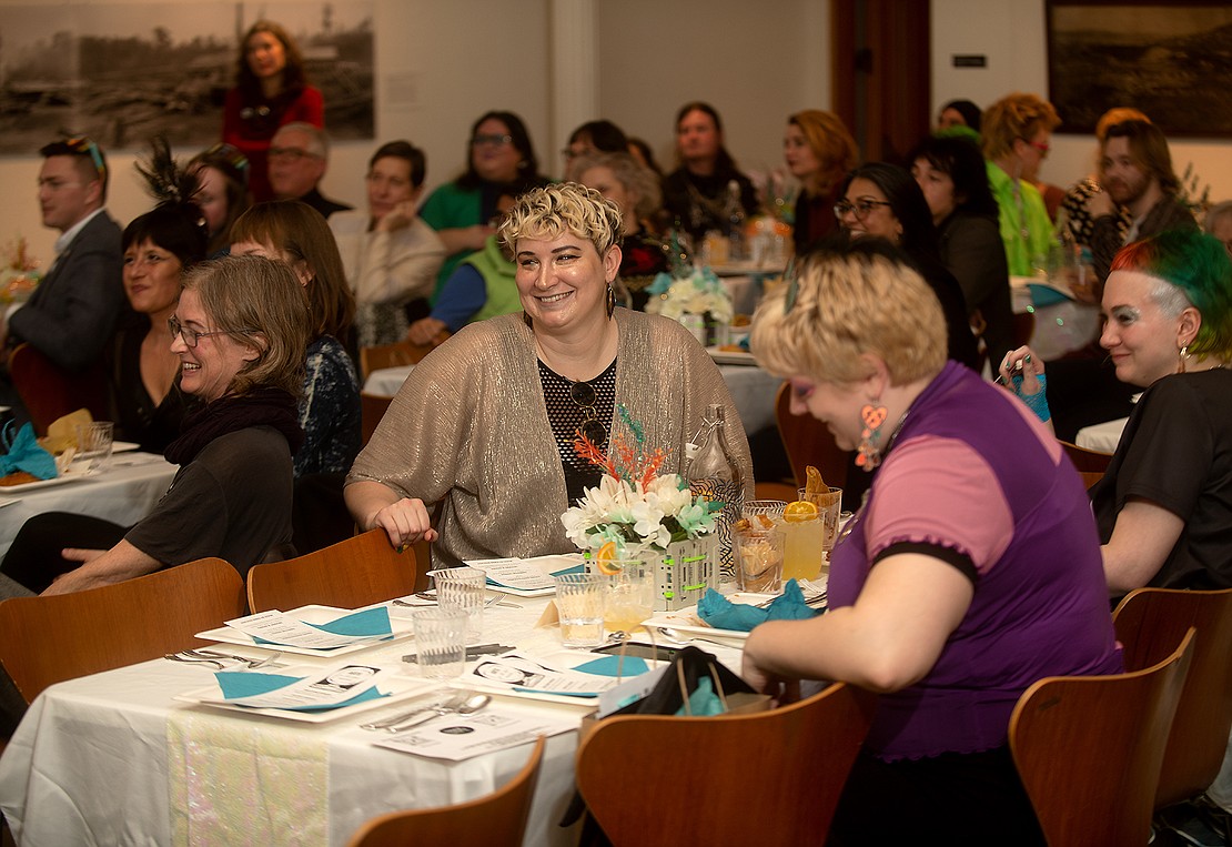 Jordan Wendland smiles while listening to speakers at the fundraiser, which more than 100 people attended.