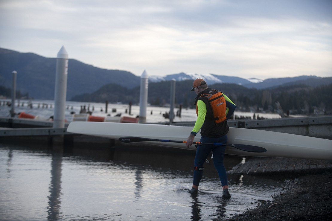 Simon Brownlie, 61, carries his surf ski kayak into the water from the shore near Bloedel Donovan Park Jan. 11 for his weekly recreational paddle around Lake Whatcom. Brownlie, a Bellingham-based attorney, learned to paddle at 6 years old in his home country of South Africa.