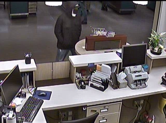 Witnesses described the suspect of a bank robbery as a 5-foot-9, white male with a regular build. At the time of the robbery on Jan. 24, he was dressed in a black hoodie, a black face covering, blue latex gloves, faded blue jeans and white shoes.