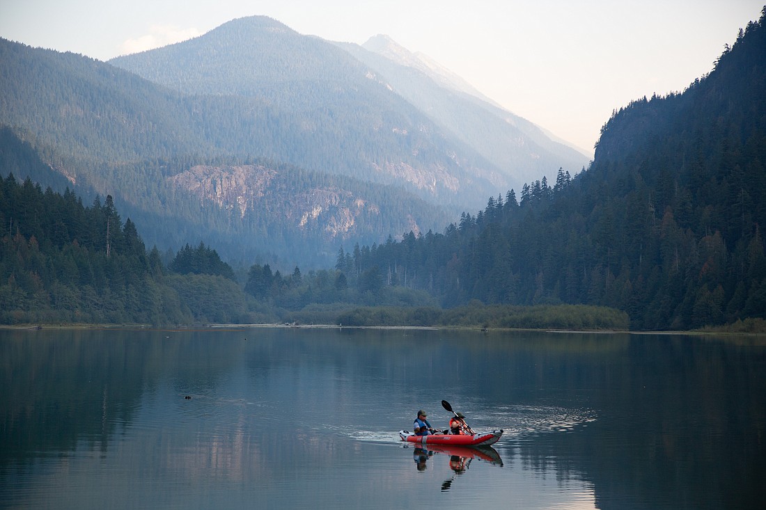 Kayakers glide through the waters of Diablo Lake in North Cascades National Park in October 2022. The park will receive significant grant funding for projects related to bear safety education, "rare carnivore" research and food sustainability programs with local tribes.
