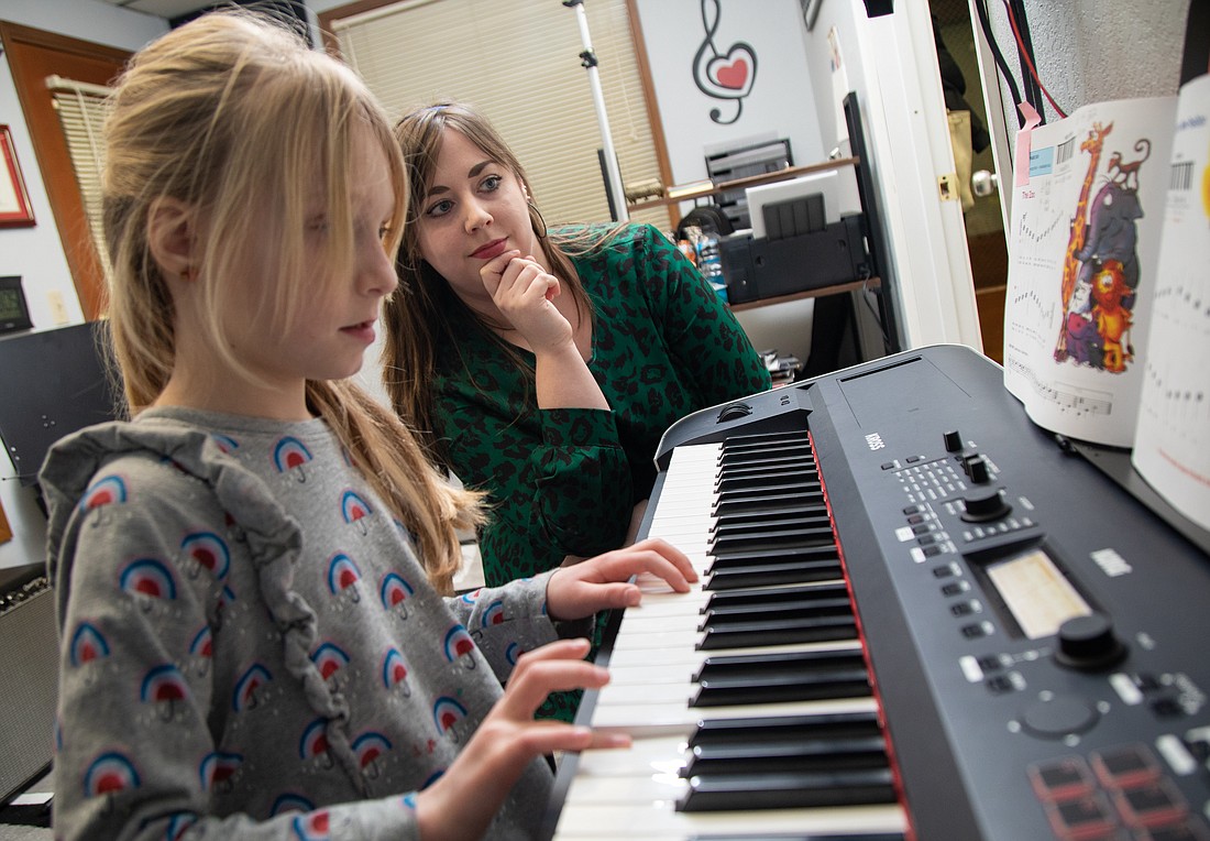 Music teacher Beverly Greencorn, right, works with student Sienna Park Jan. 23 at Beverly's Music School in Bay Street Village on Holly Street. Greencorn opened the permanent location Jan. 2 after teaching piano, guitar and ukulele remotely since August 2022.