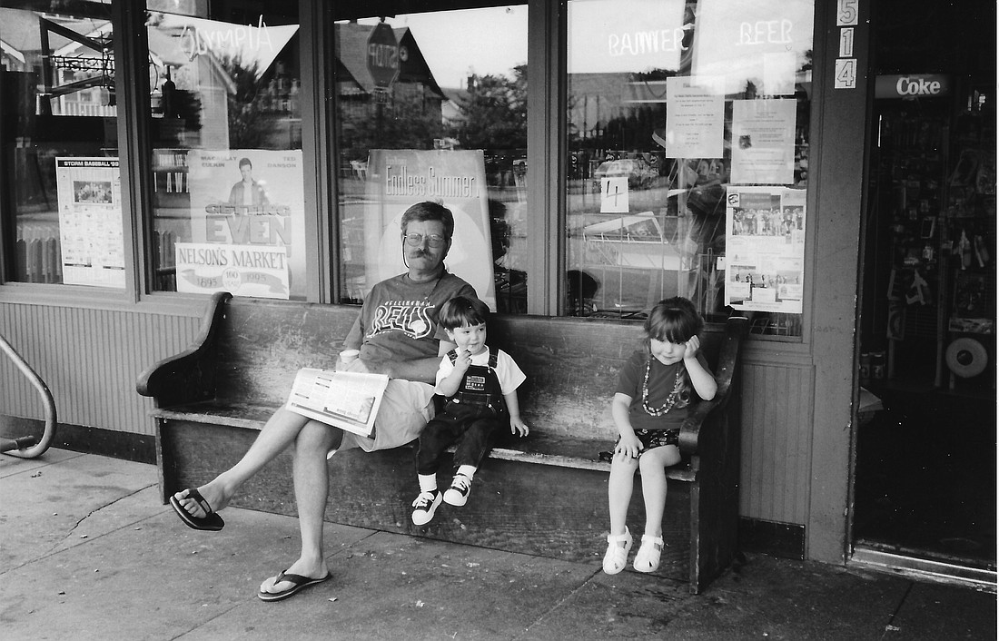 Jon Ostby, who purchased Nelson's Market in 1984, sits on a bench in front of the York neighborhood hub reading the paper and visiting with a couple of local kids. Ostby passed away recently at age 75.