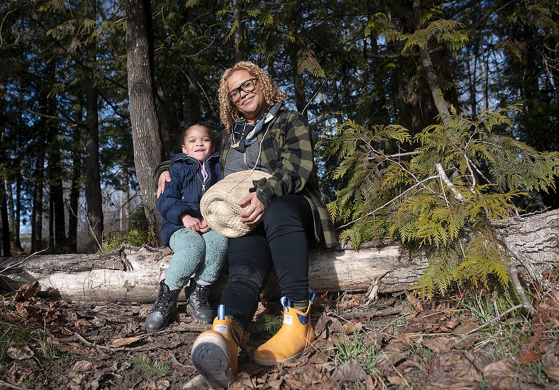 Portia Kors, esthetician and owner of Skin Rhythm, collects cottonwood buds Jan. 29 with her daughter, Naomi, at Nugent's Corner River Access. The buds are natural preservatives and can be used for skin care.