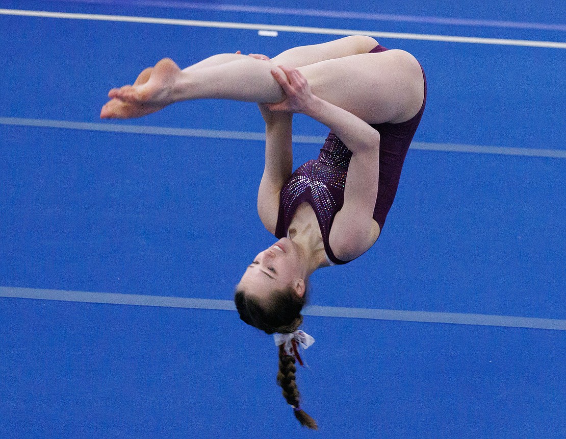 Laura Webb performs a front pike as the Bellingham United Gymnastics team competes against Ballard and Nathan Hale high schools on Jan. 29. Webb finished fifth.