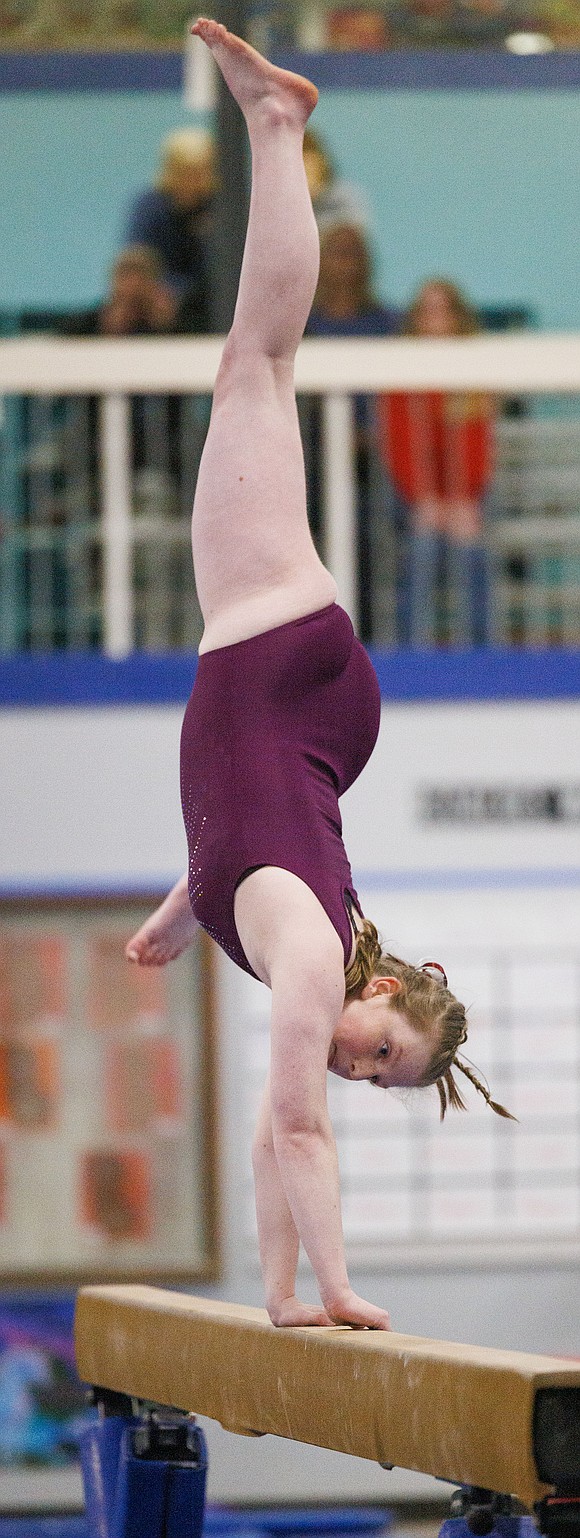 Naomi Stelling competes on the balance beam for Bellingham United Gymnastics during the meet.