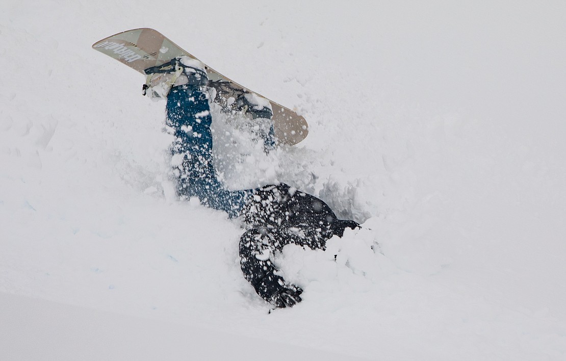 A snowboarder takes a crash on the course.