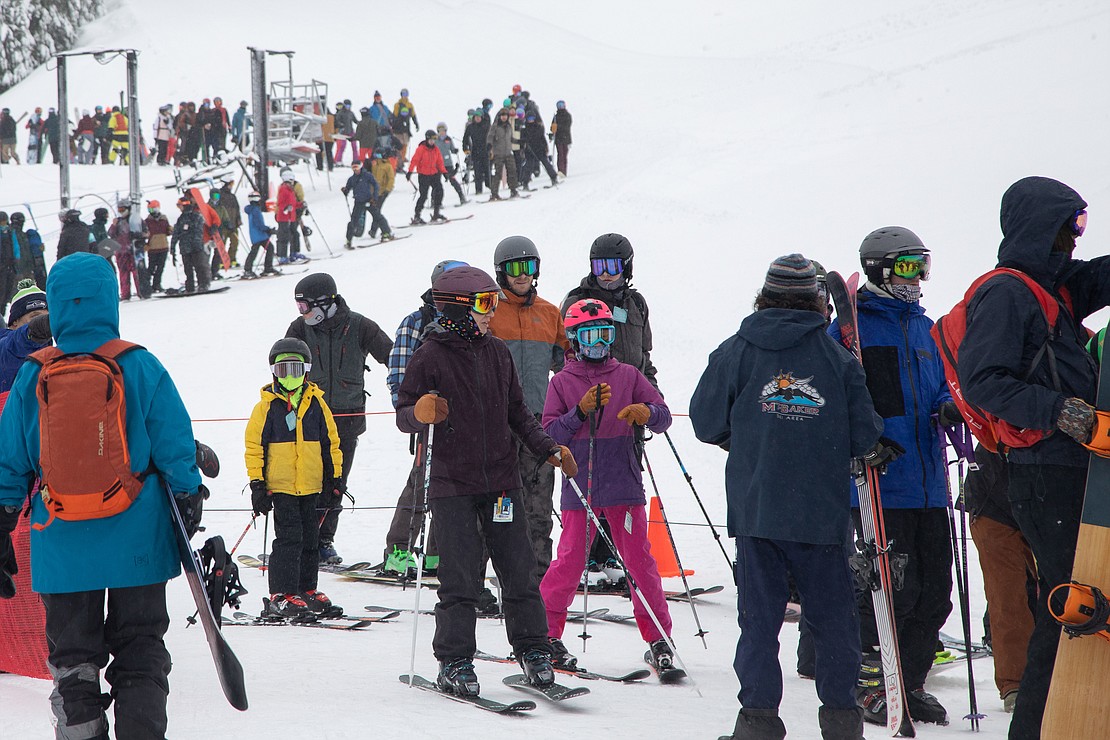 Dozens of people line up to catch the first lift of the day on Chair 7 from White Salmon Lodge at 9:15 a.m. The Legendary Banked Slalom brought hundreds of additional people to the slopes of Mount Baker Ski Area.