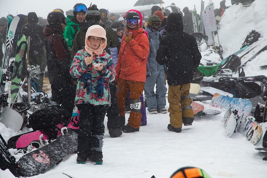 Josie Weeks, 11, of Lynden, eats a chocolate-covered strawberry while waiting for her race at the top of Chair 5.