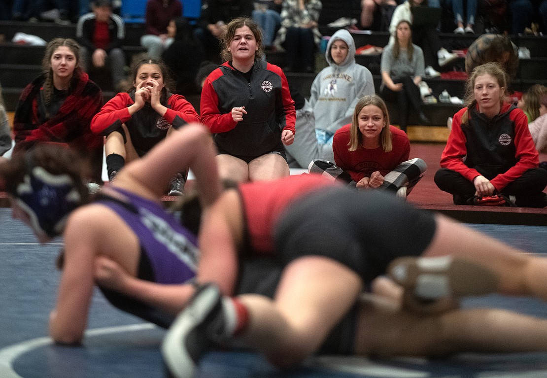 Mount Baker wrestlers cheer on Melanie Wilson from the sideline Feb. 4 during her match against Alita Ciron-penton in the 140-pound third-place match at the 1B/2B/1A/2A North Sub-Regional Girls Wrestling Tournament at Squalicum High School. Wilson pinned Ciron-penton in 4:37.