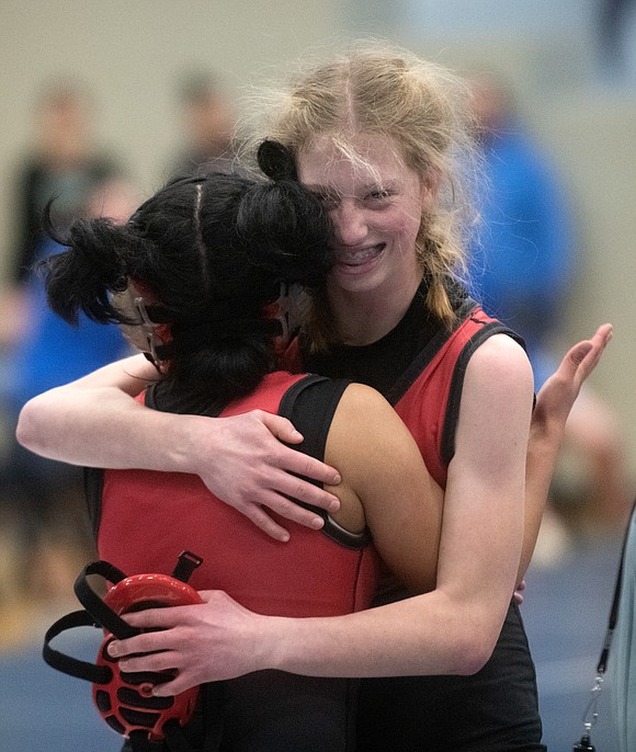 Mount Baker's Karalyn Cook hugs Mount Baker's Ana Camacho after competing against one another in the 110-pound first-place match. Camacho pinned Cook in 1:11.