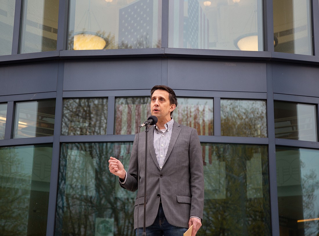 Rep. Alex Ramel speaks in front of the Whatcom County Courthouse in May 2022. Ramel, a Bellingham Democrat, is sponsoring a bill in the Washington state Legislature that would cap rent increases at the inflation rate.