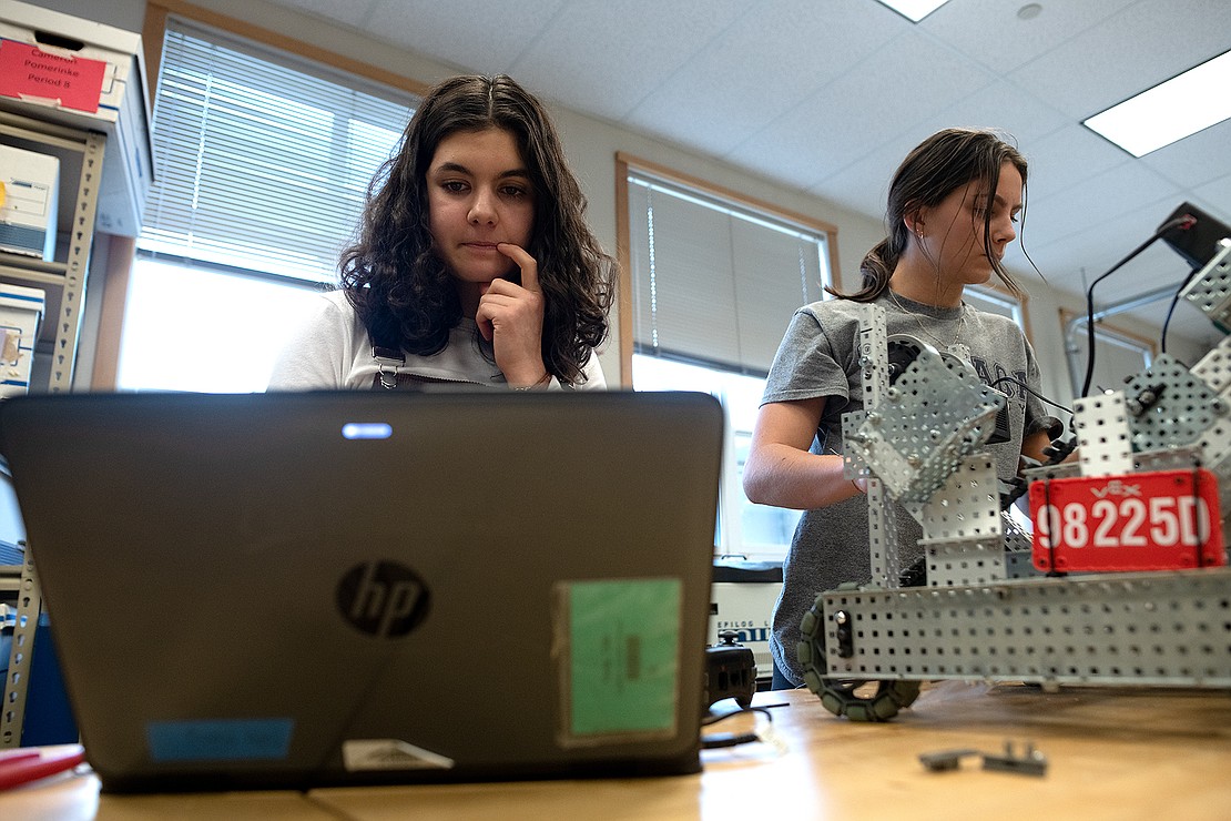 Bellingham junior Calla Young and sophomore Katie Knies try to solve a coding issue with their robot Feb. 8 during robotics class at Bellingham High School. "It's a good combination of frustrating and fun," Young said.