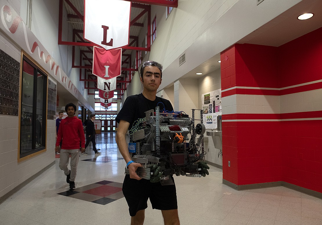 Sam Goldsberry carries his team's robot at the VEX Robotics Competition Feb. 11 at Bellingham High School.