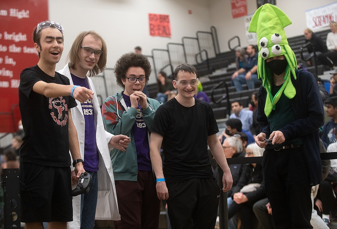Students from Bellingham, Lake Stevens and Sehome high schools react to the expansion of the robots during the Round of 16 at the VEX Robotics Competition on Feb. 11.