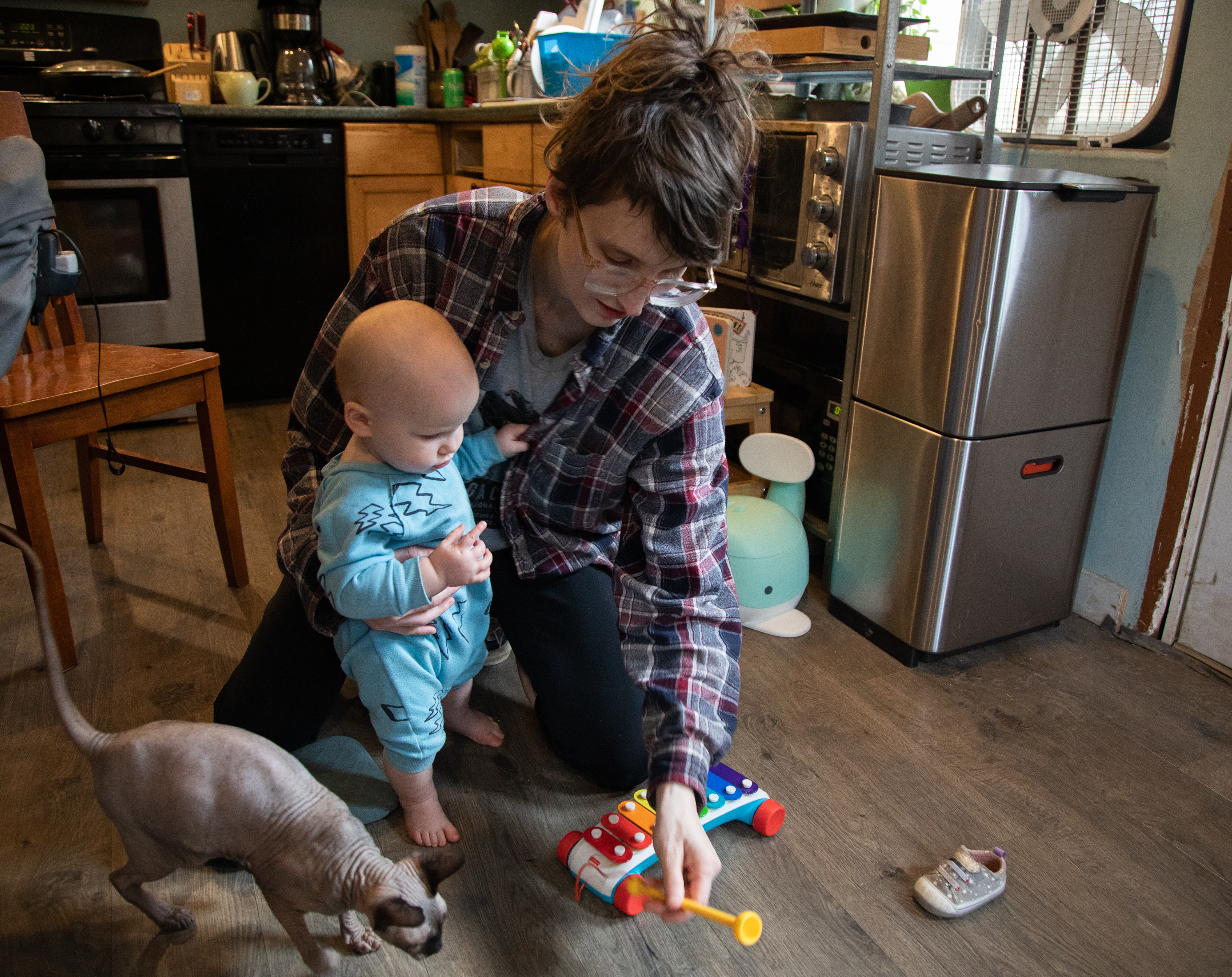 Laura Klotzer, 32, engages 10-month-old Ember with a toy Feb. 9 in their Bellingham home. Klotzer quit her job to take care of Ember.