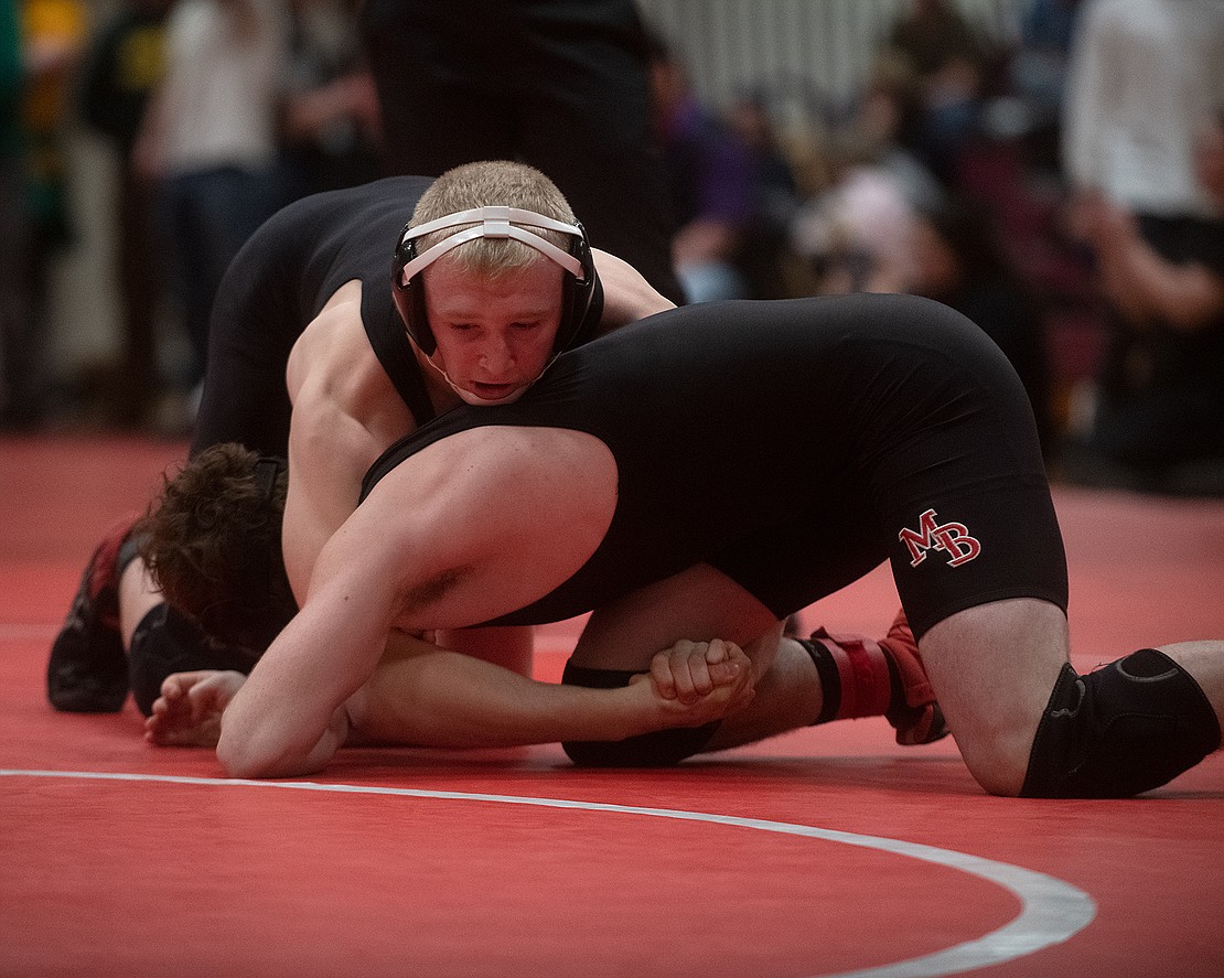 Mount Baker's Elijah Washburn interlocks his hands around Mount Baker's Vance Lawrence before pinning him in 1:27 during the championship match of the 170-pound weight class.