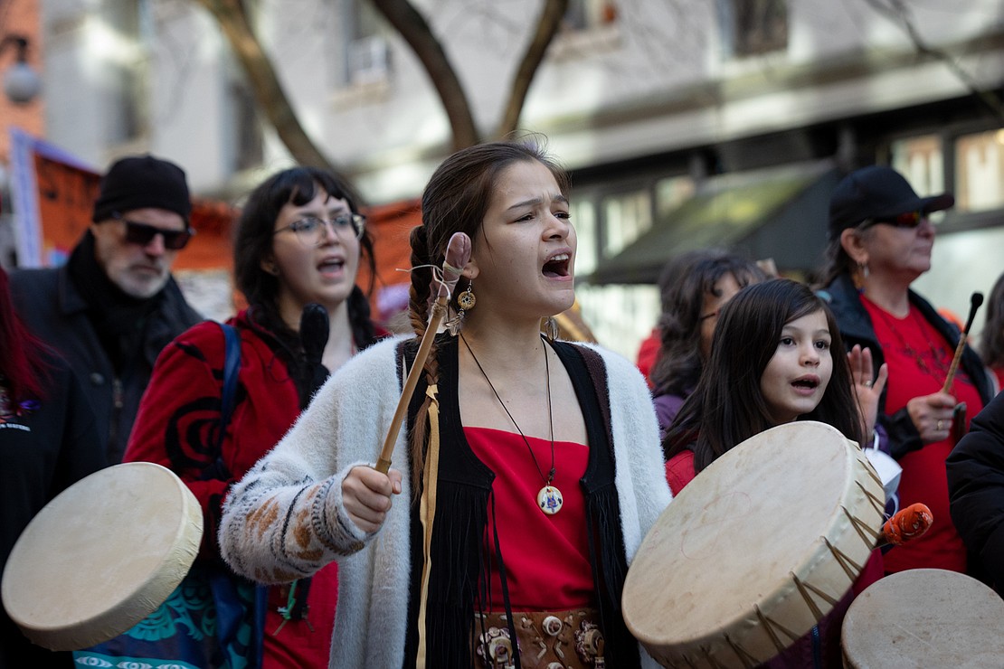 Young female drummers march down Water Street in Vancouver’s Gastown.