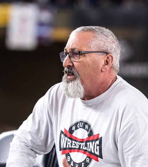 Mount Baker coach Clyde Blockley shouts instruction to one of the Mountaineer wrestlers,