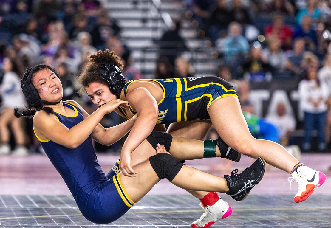 Ferndale’s Malia Welch, right, takes down Everett’s Shannon Chang in the 120-pound bracket.