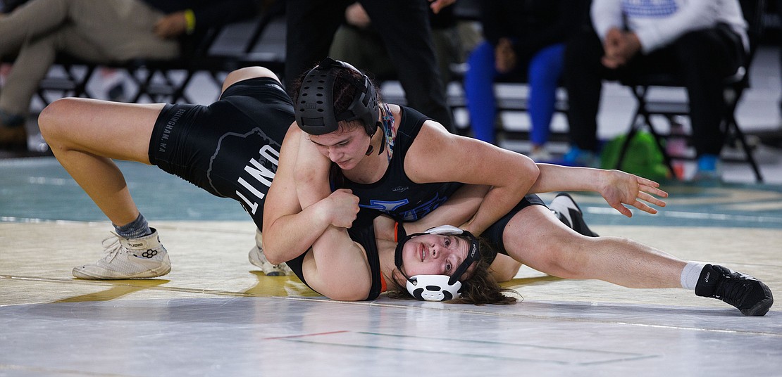 Bellingham United’s Frances Porteous tries a bridge move to avoid a pin by Curtis’ Clarissa Wagen in their championship match. Porteous was pinned by Wagen in the second period.