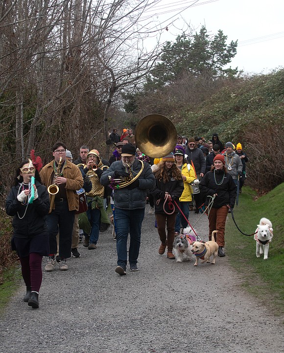 The Mighty Bayou Opossums, a local New Orleans tribute band, plays a rendition of "Oh When the Saints" and leads a march of around 100 people and their pups from Boulevard Park to Paws For a Beer in an inaugural dog-themed Mardi Gras parade.