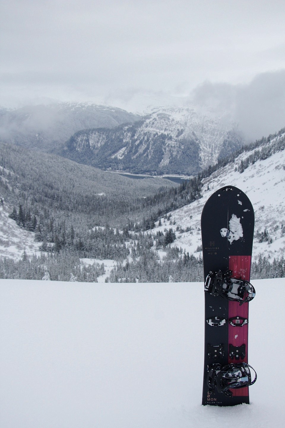 CDN outdoors columnist Kayla Heidenreich's snowboard stands up in the snow in the Tongass National Forest. Snowboarding for work and play requires balance.