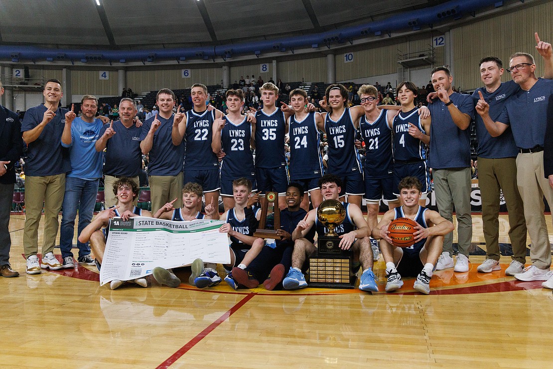 Lynden Christian poses with the 1A state championship trophy and gold ball.