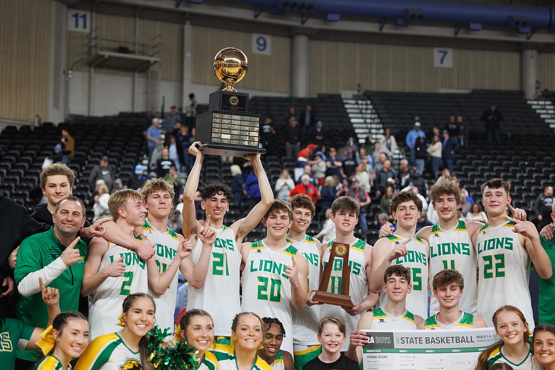 Lynden players, coaches and cheerleaders celebrate after Lynden beat Mark Morris 61-43 in the 2A state championship game March 4 at the Yakima Valley SunDome.