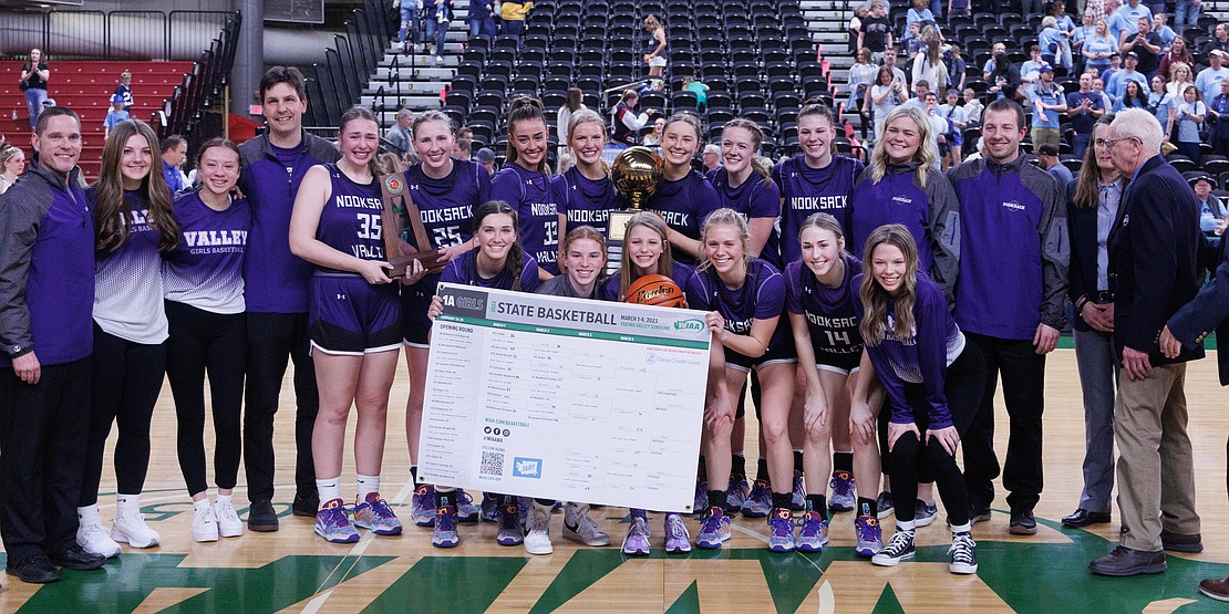 Nooksack Valley poses with the gold ball and tournament bracket after winning the 1A state championship.