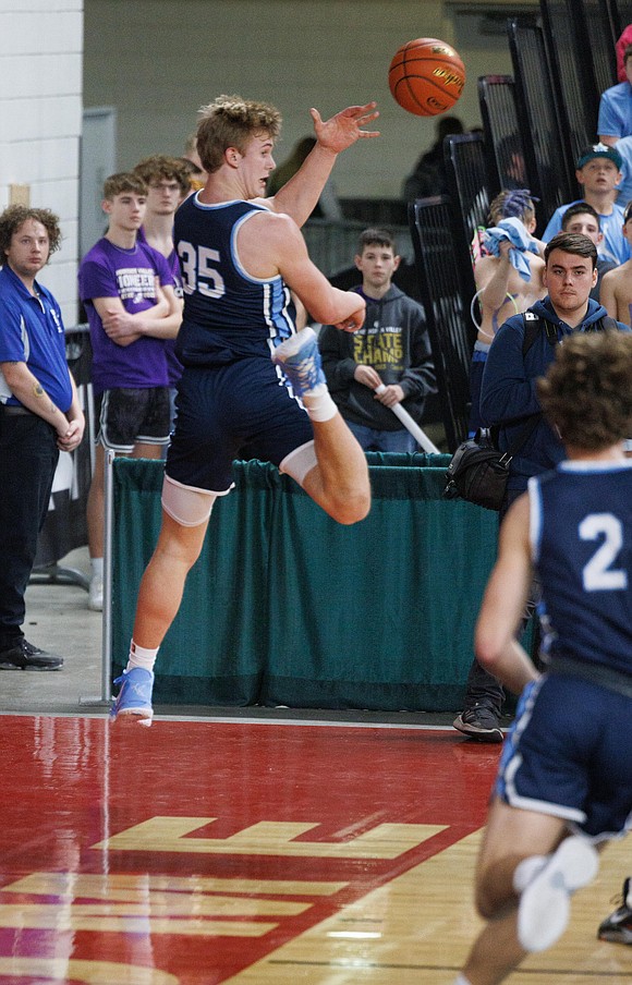 Lynden Christian's Jeremiah Wright leaps to try and keep the ball in play against King's.