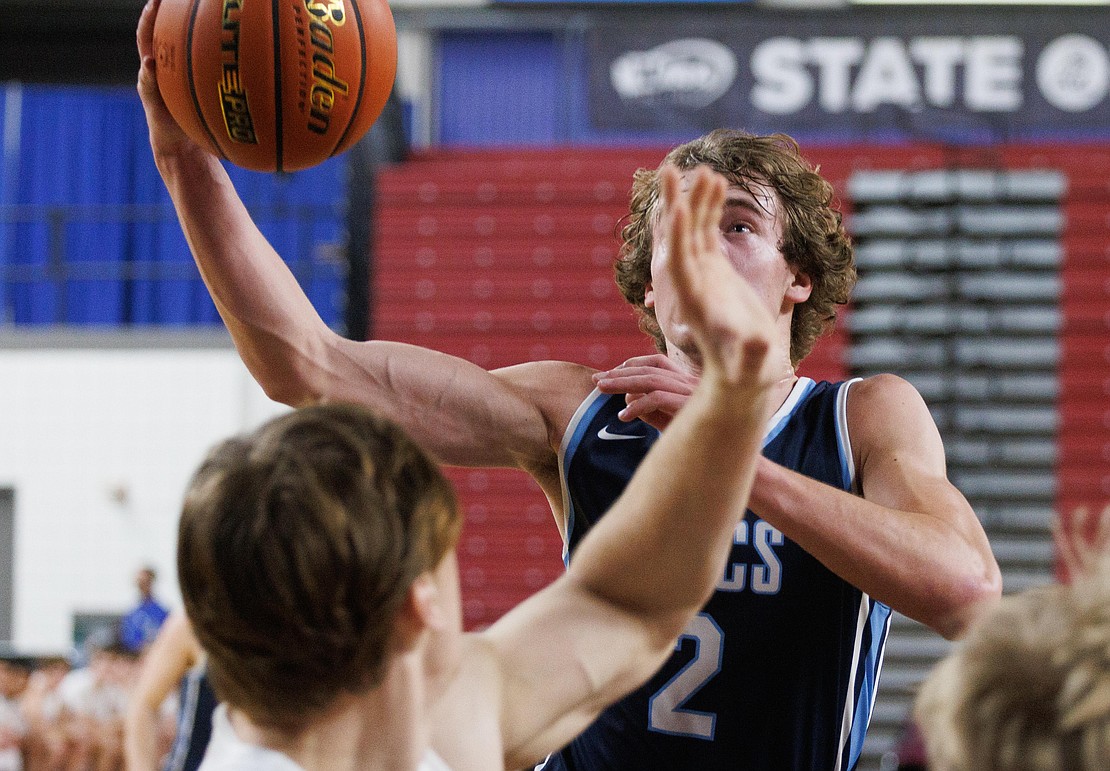 Lynden Christian's Dawson Bouma looks to the basket a he gets a layup in the fourth quarter.