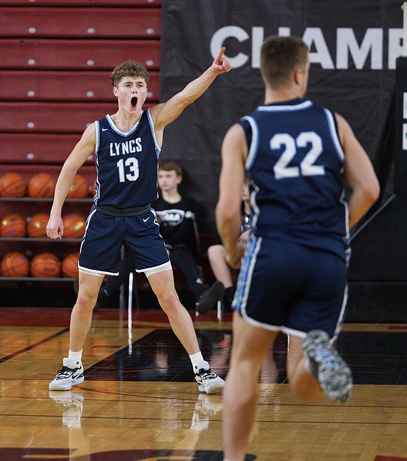 Lynden Christian’s Griffin Dykstra points a finger and yells after sinking a 3-pointer.