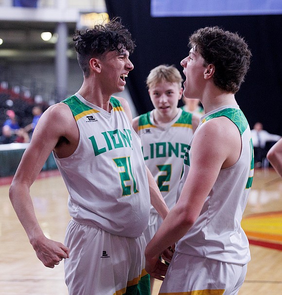 Lynden's Anthony Canales and Treyson Smiley celebrate as a Mark Morris player fouls out of the game.
